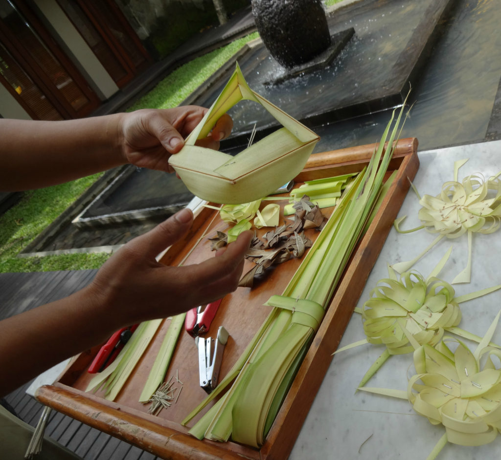 There are intricate details to making/creating an offering to bring to the Temples. You need Coconut Palm Leaves, Bamboo Skewers for threading the pieces together, or you can use a stapler. ;)